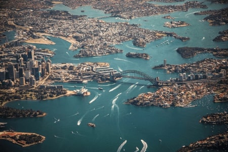 Sydney harbour air shoot with boasts and ferries crossing the waterways.